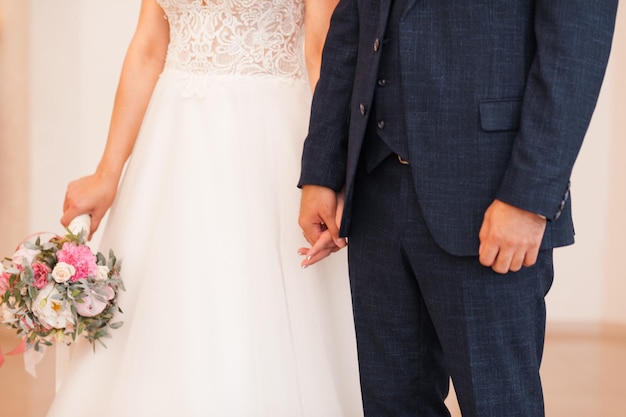 The bride and groom in medical masks exchange rings 3833