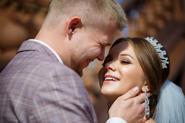 Bride and groom passionately hug on wedding day.