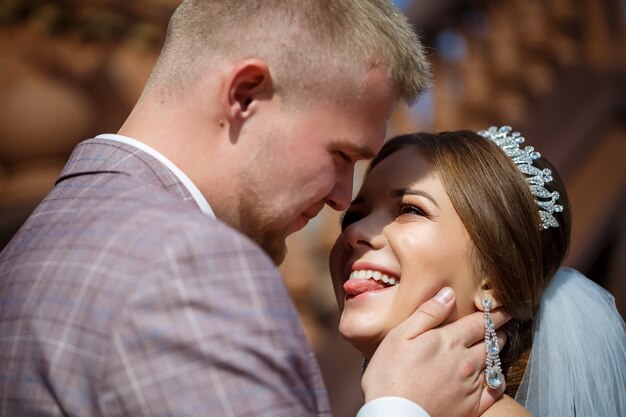 Bride and groom passionately hug on wedding day.