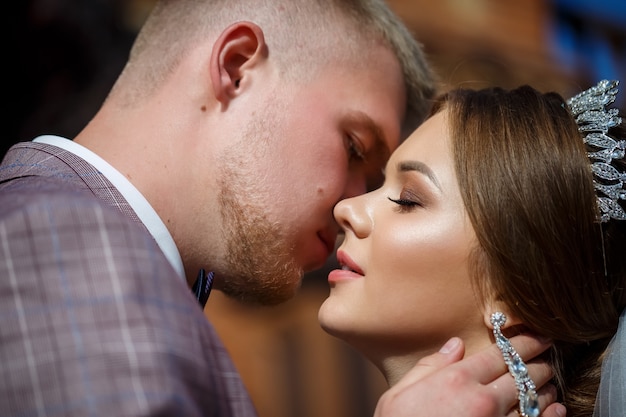 Bride and groom passionately hug on wedding day.