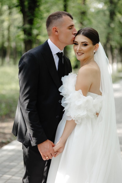 a bride and groom pose for a photo