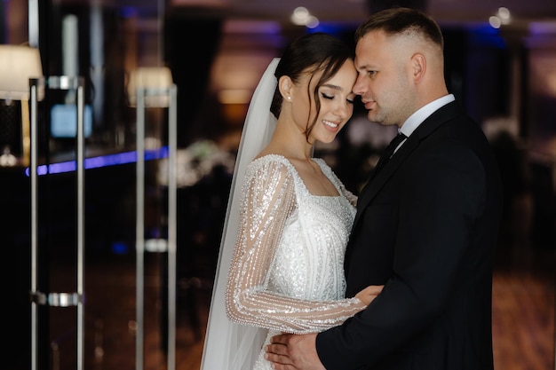 a bride and groom pose for a photo