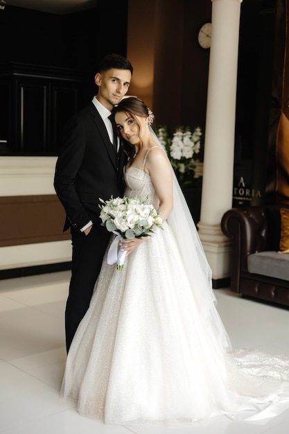 a bride and groom pose for a photo