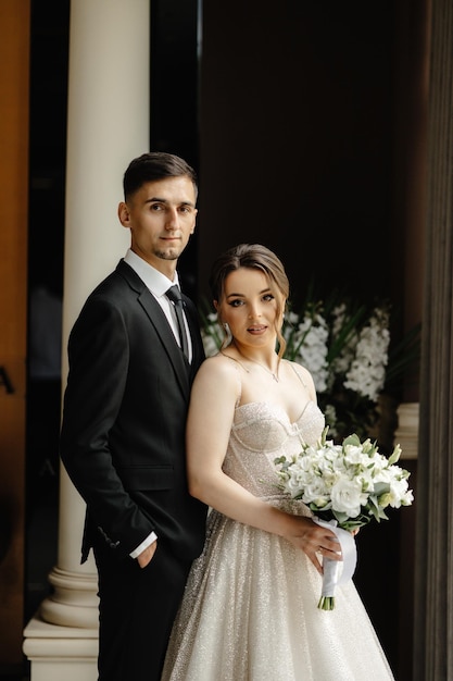 a bride and groom pose for a photo