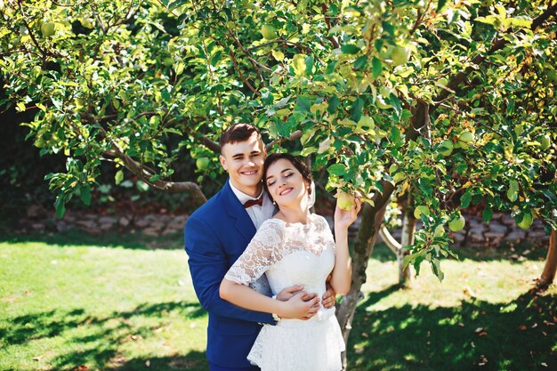 Bride and groom posing in a park