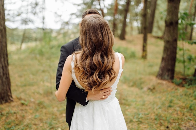 The bride and groom run through a forest Wedding photo shoot