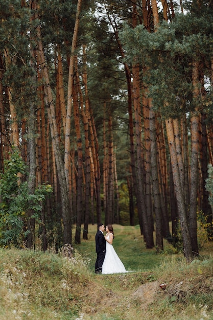 The bride and groom run through a forest Wedding photo shoot