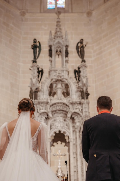 Bride and groom standing in front of a altar