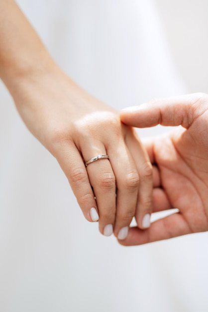 The bride and groom tenderly hold hands between them love and relationships