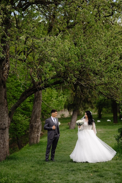 Bride and groom walk in the woods