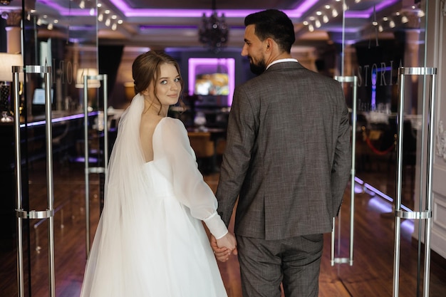 Bride and groom walking in a restaurant