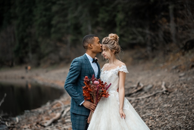 Bride and groom at wedding ceremony on the beautiful lake.