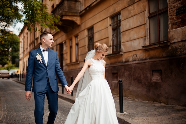 Bride and Groom on Wedding Day in city. Wedding couple after wedding ceremony.