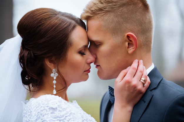 Bride and groom at wedding day outdoors. Newlyweds man and woman. Happy couple at wedding day. funny wedding details. soft tonality