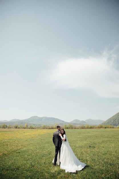 Bride and Groom at wedding Day walking Outdoors on summer green nature.