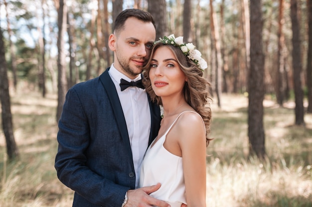 Bride and groom at wedding Day walking Outdoors on summer nature. 