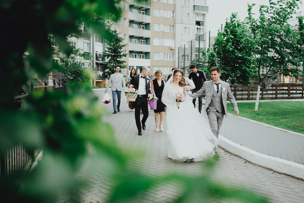 The bride and groom and the youth walk