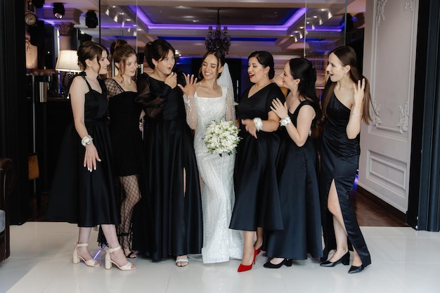 a bride and her bridesmaids are laughing and laughing