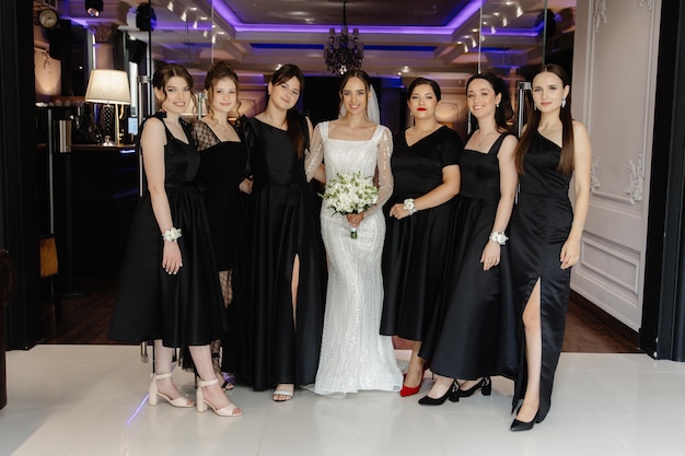 a bride and her bridesmaids pose for a photo