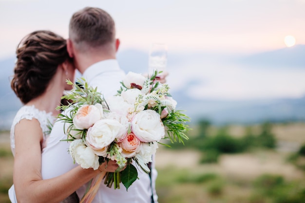 Bride hold wedding bouquet of rose peonies and roses Hands close up