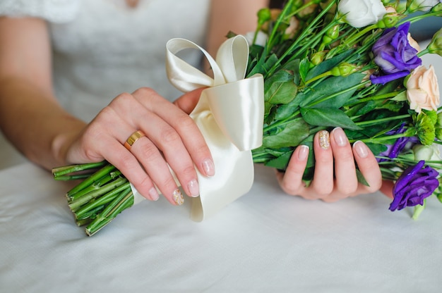 Bride holding beautiful wedding bouquet in wedding day