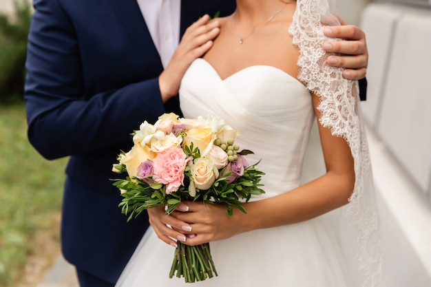 Bride holding beautiful wedding bouquet