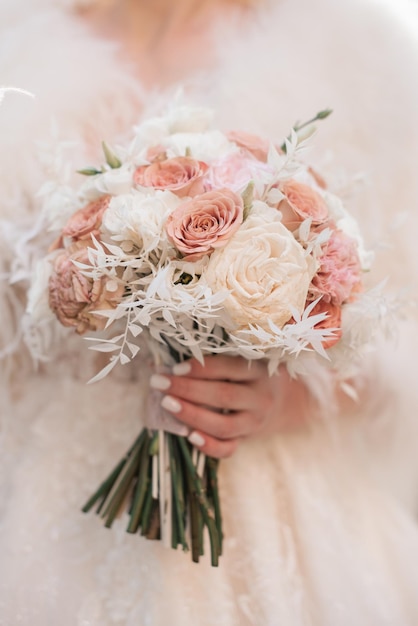 Bride holding beautiful white wedding bouquet Closeup