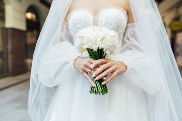 Bride holding bouquet of roses berries and eustoma