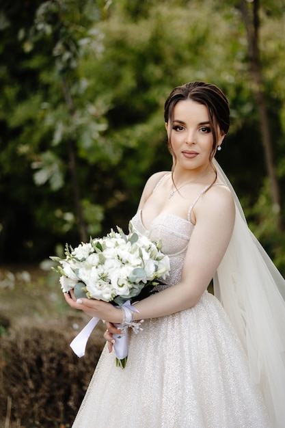 bride holding a bouquet of white roses