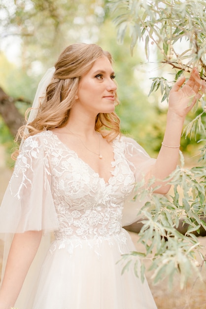 Bride holding a branch of tree