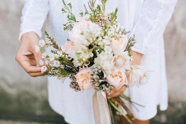 Bride holding the wedding bouquet with beautiful flowers rustic stylex9