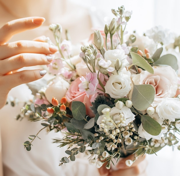 Bride holding wedding bouquet with white and pink flowers