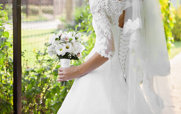 The bride holds the beautiful wedding bouquet