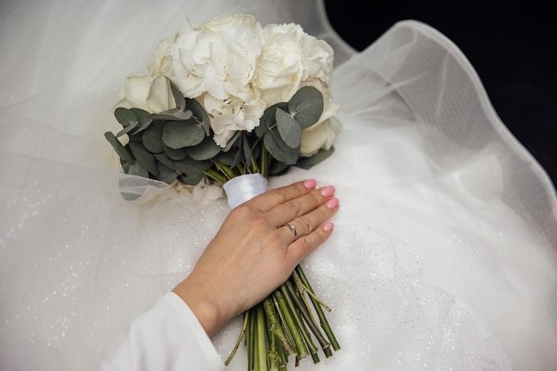 Bride holds a wedding bouquet wedding dress wedding details