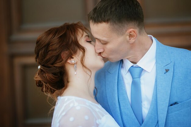 Bride in a light wedding dress to the groom in a blue suit