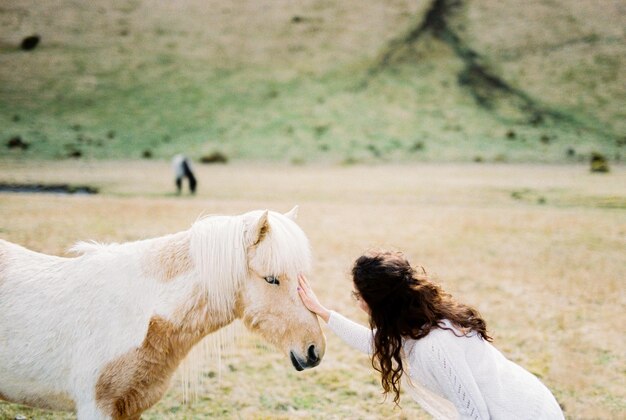 Bride strokes a whitered horse iceland