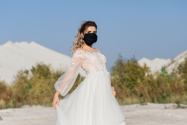 Bride in wedding dress with medical mask