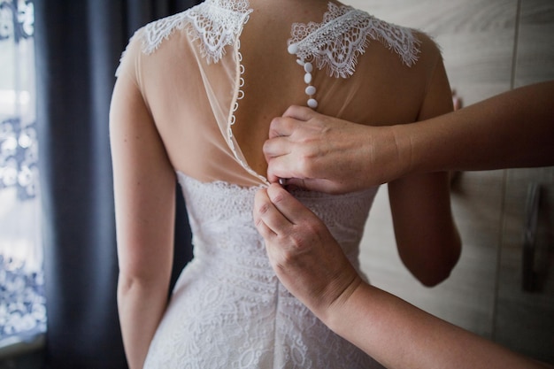 The bride at the wedding is wearing a wedding dress