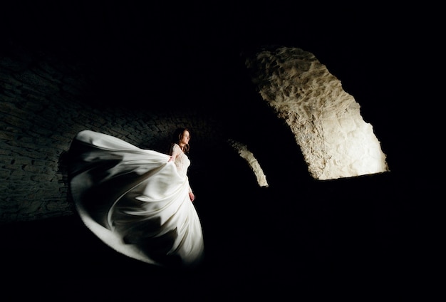 Bride whirls in a tunnel with light