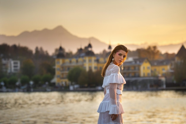 A bride in a white wedding dress in the old town of Austria at sunset