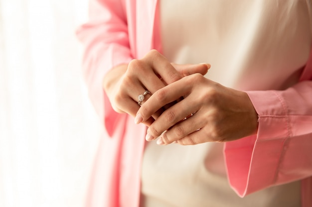 Bride with engagement ring at wedding day.