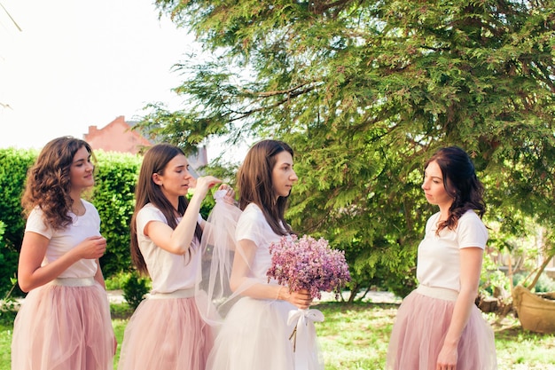 Bridesmaids are preparing the bride to the wedding