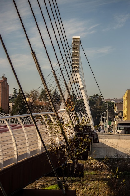 Bridge by buildings against sky in city