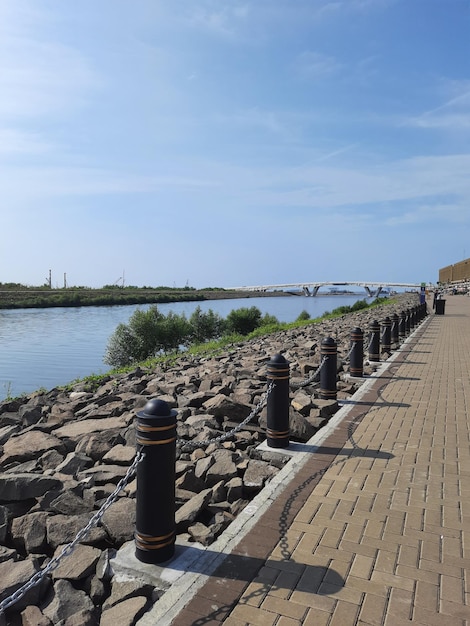 A bridge over a canal with a sea view