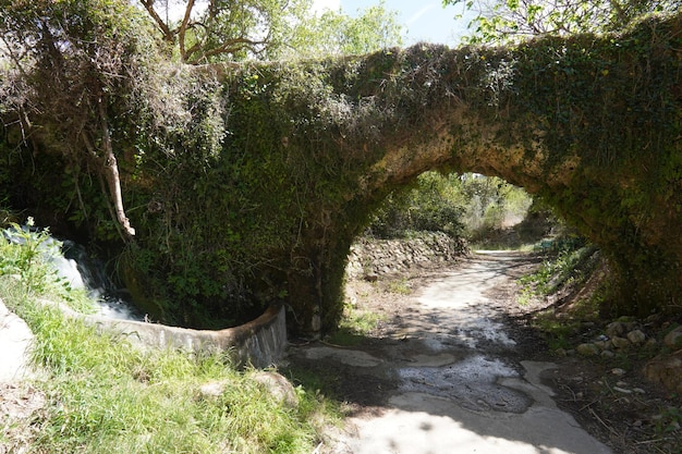 A bridge over a creek with a stone bridge and a bridge over it.