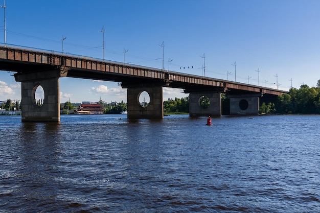 Bridge on a river against a blue sky and clouds