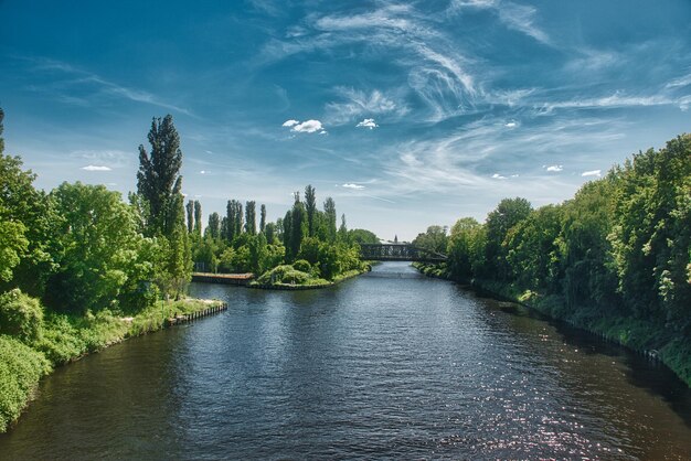 Bridge over river against blue sky in summer