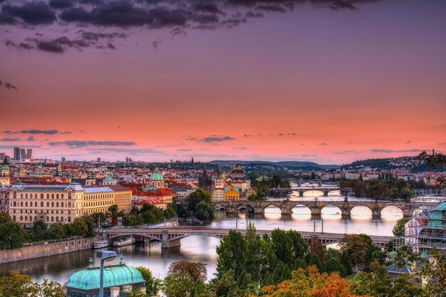 Bridge over river against sky during sunset