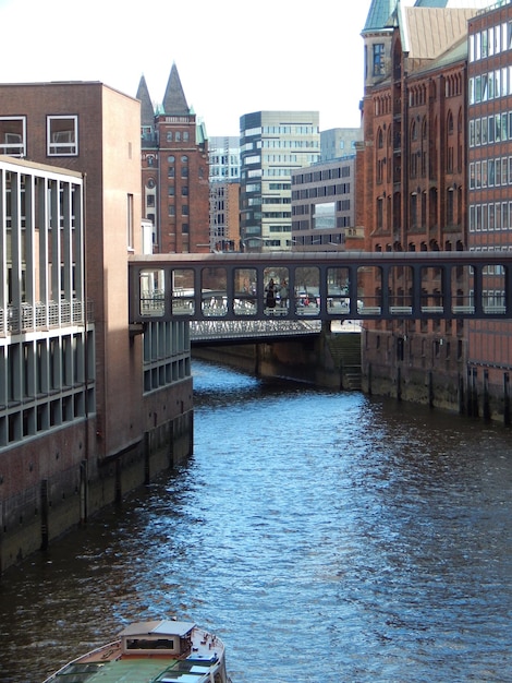 A bridge over a river with a building in the background