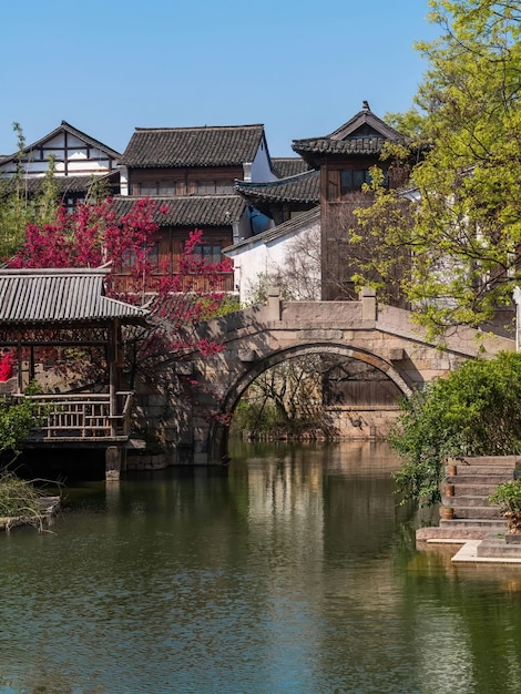 A bridge over a river with a building in the background